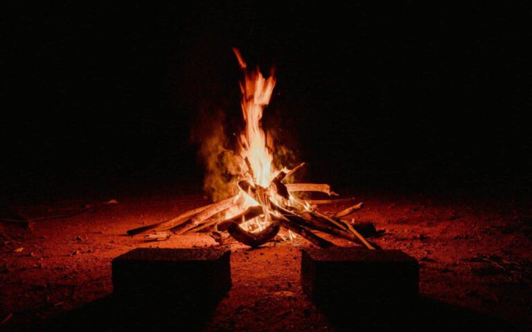 A warm campfire burning brightly against the dark night in Pedra Bela, Brazil. Beltane