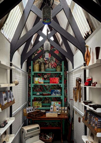 Interior of a charming small shop displaying various items, including some overrated products with vintage-style decor and cozy ambiance.
