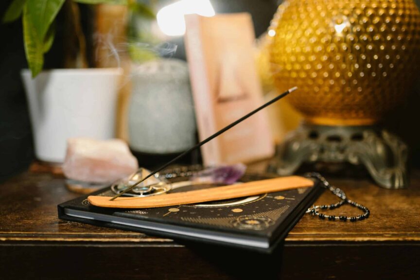 A tranquil setting featuring incense, crystals, and a glowing lamp for spiritual rituals. healing. mercury in cancer