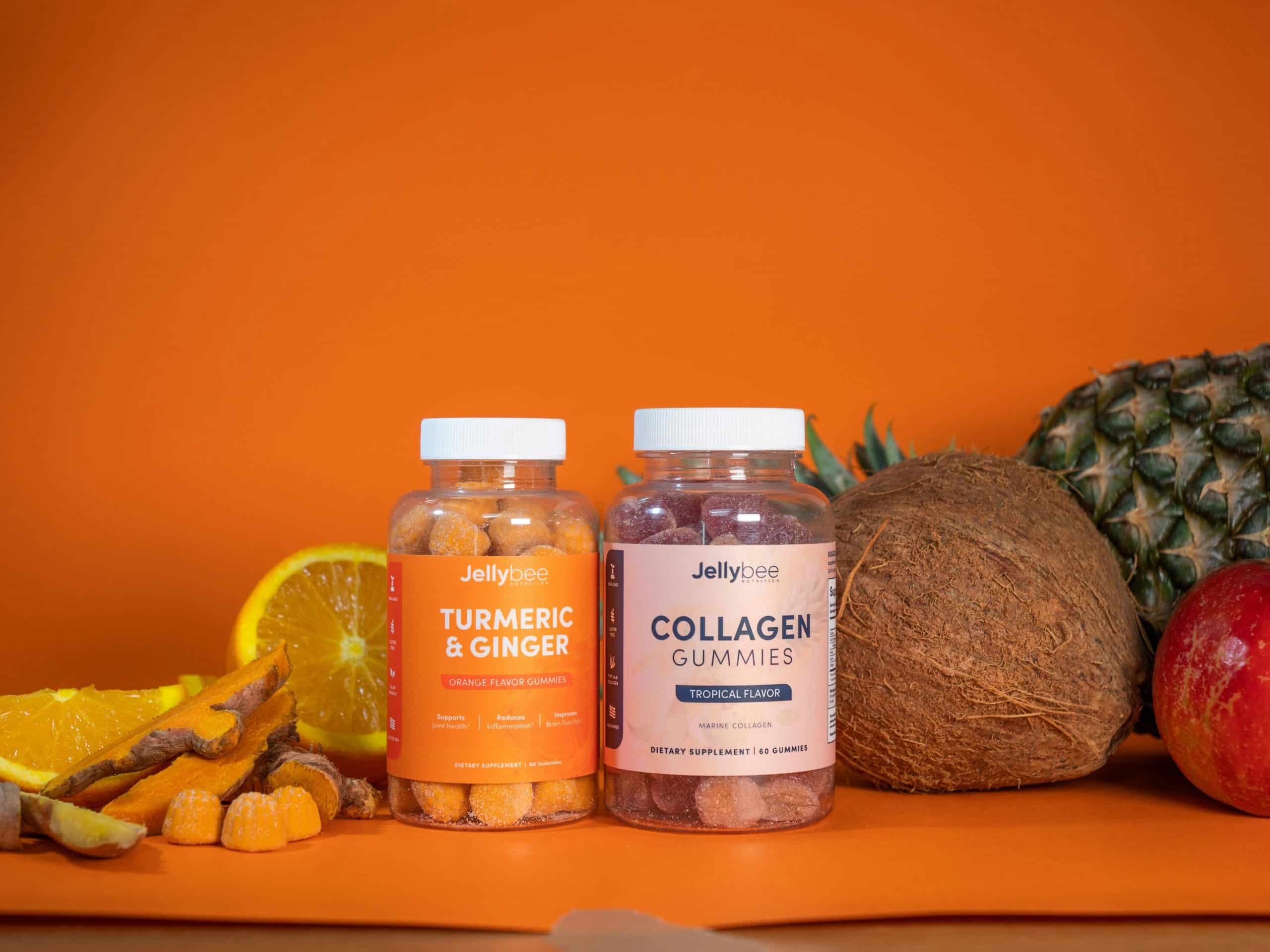 Colorful tropical beauty supplements in gummy form, surrounded by fresh fruits like coconut, pineapple, and orange.