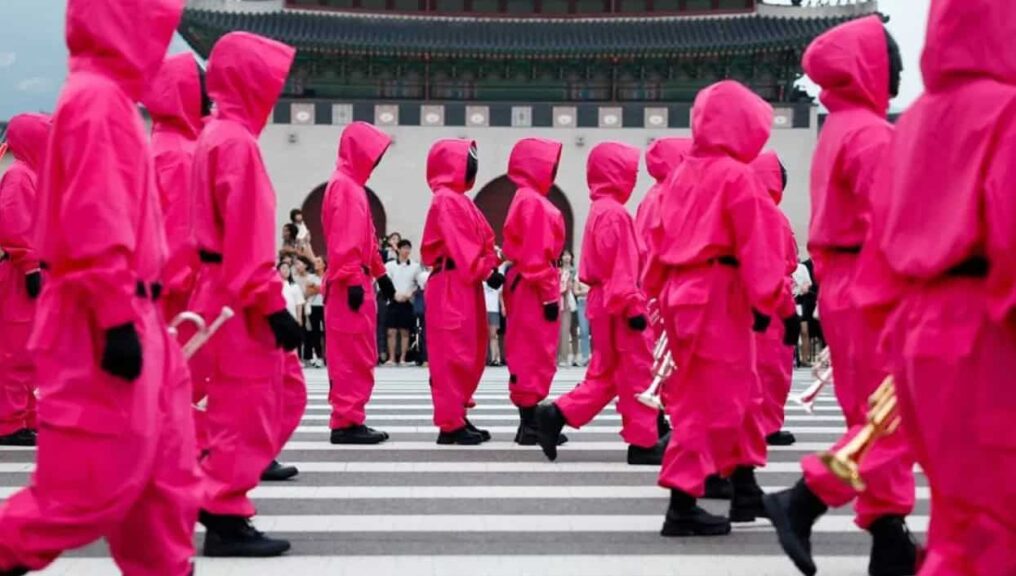 Performers dressed as "Squid Game" soldiers march in a parade through central Seoul.