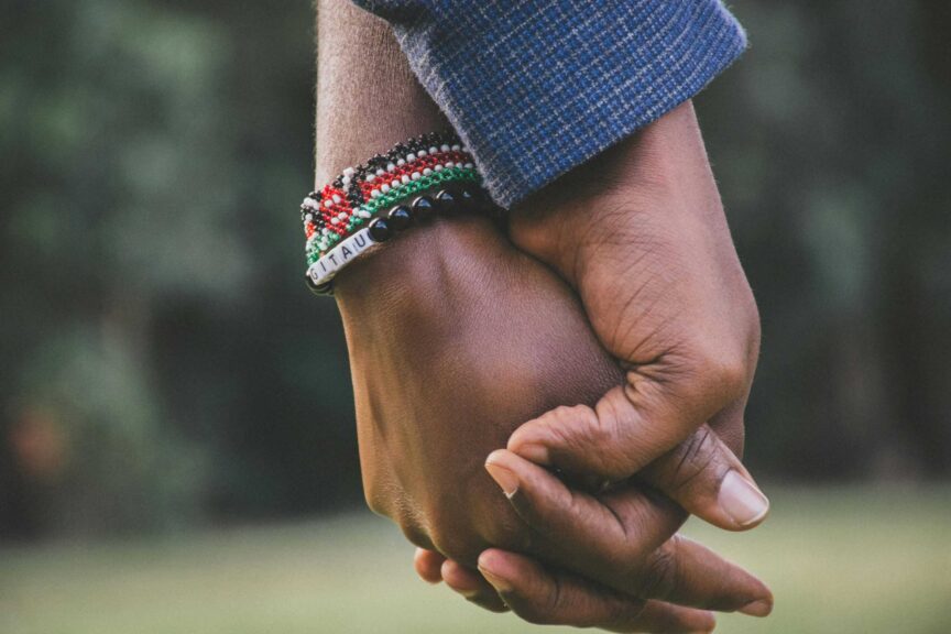 A close-up view of a couple holding hands, symbolizing love and togetherness. break. relationship