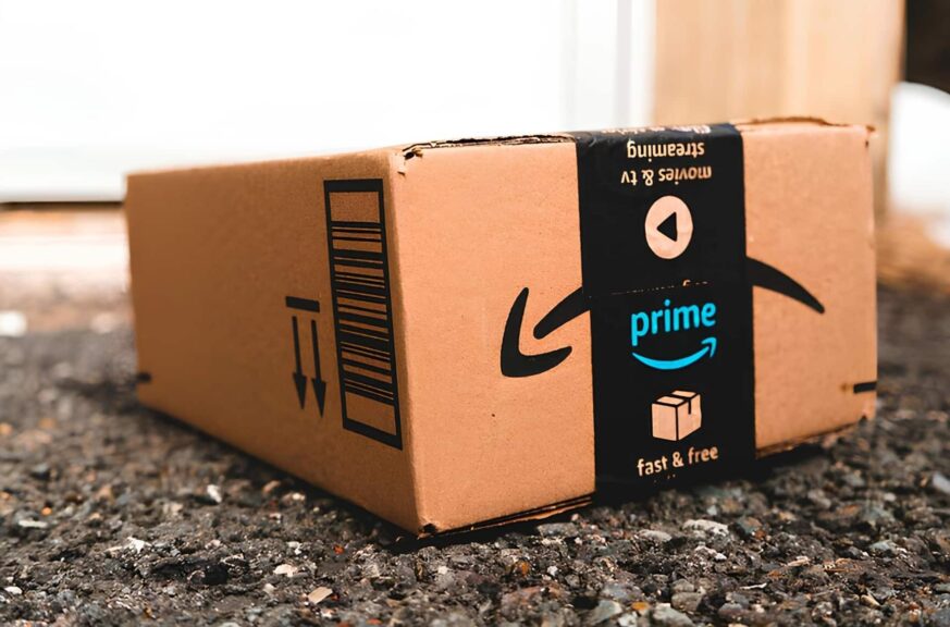 medium amazon prime day package laid on gravel of a driveway in front of a garage