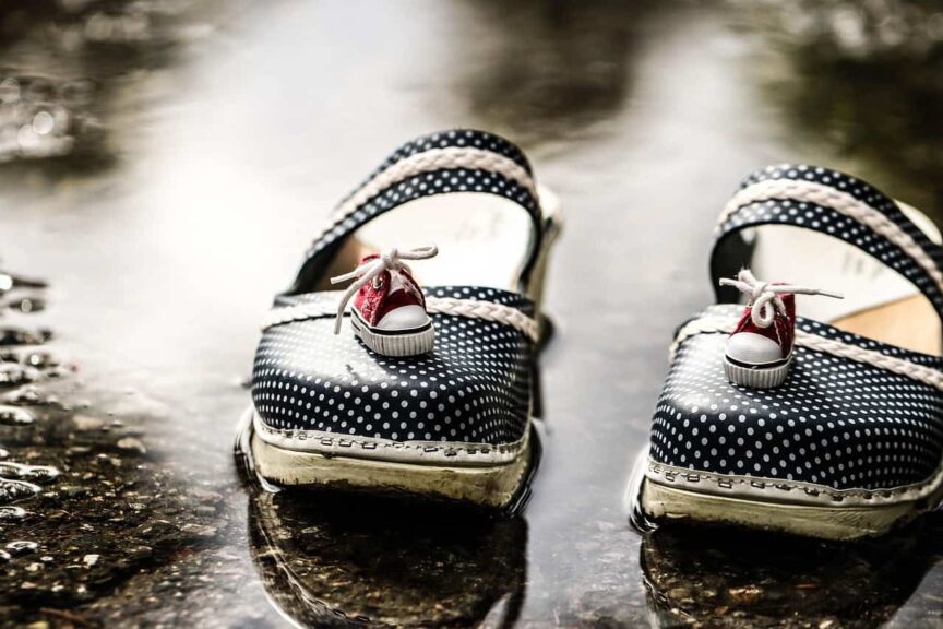 This is an image of clogs outside after a rainy day. The clogs have little sneakers on top of them. Slip-on clogs such as these can be both comfortable and stylish.