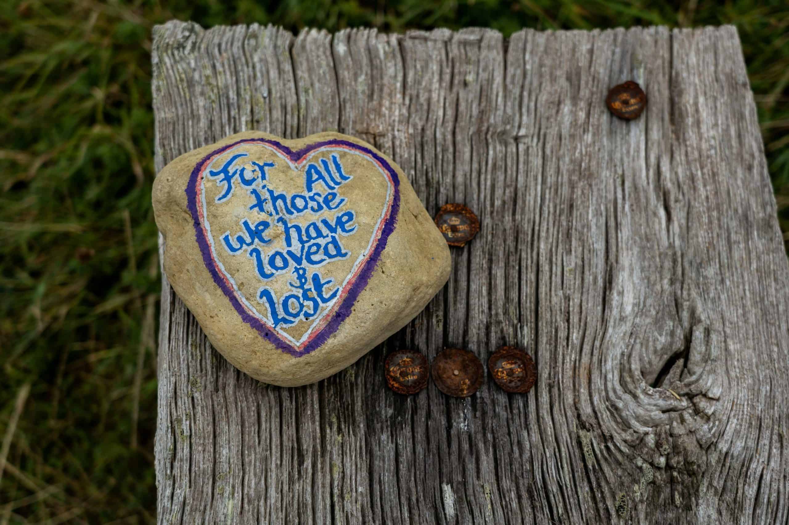 Grief: A heart-shaped rock with the words "For all those we have loved & Lost" painted on it.