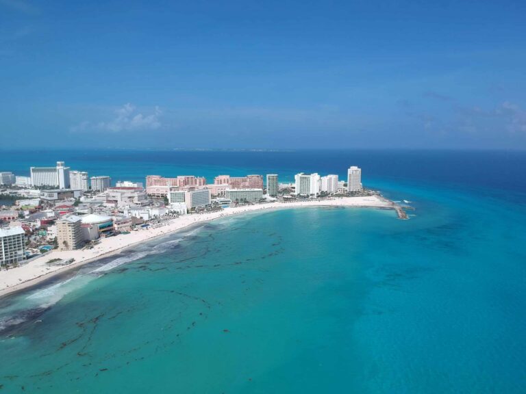 Discover the vibrant turquoise waters and pristine beaches of Cancun's iconic shoreline. Caribbean tourism