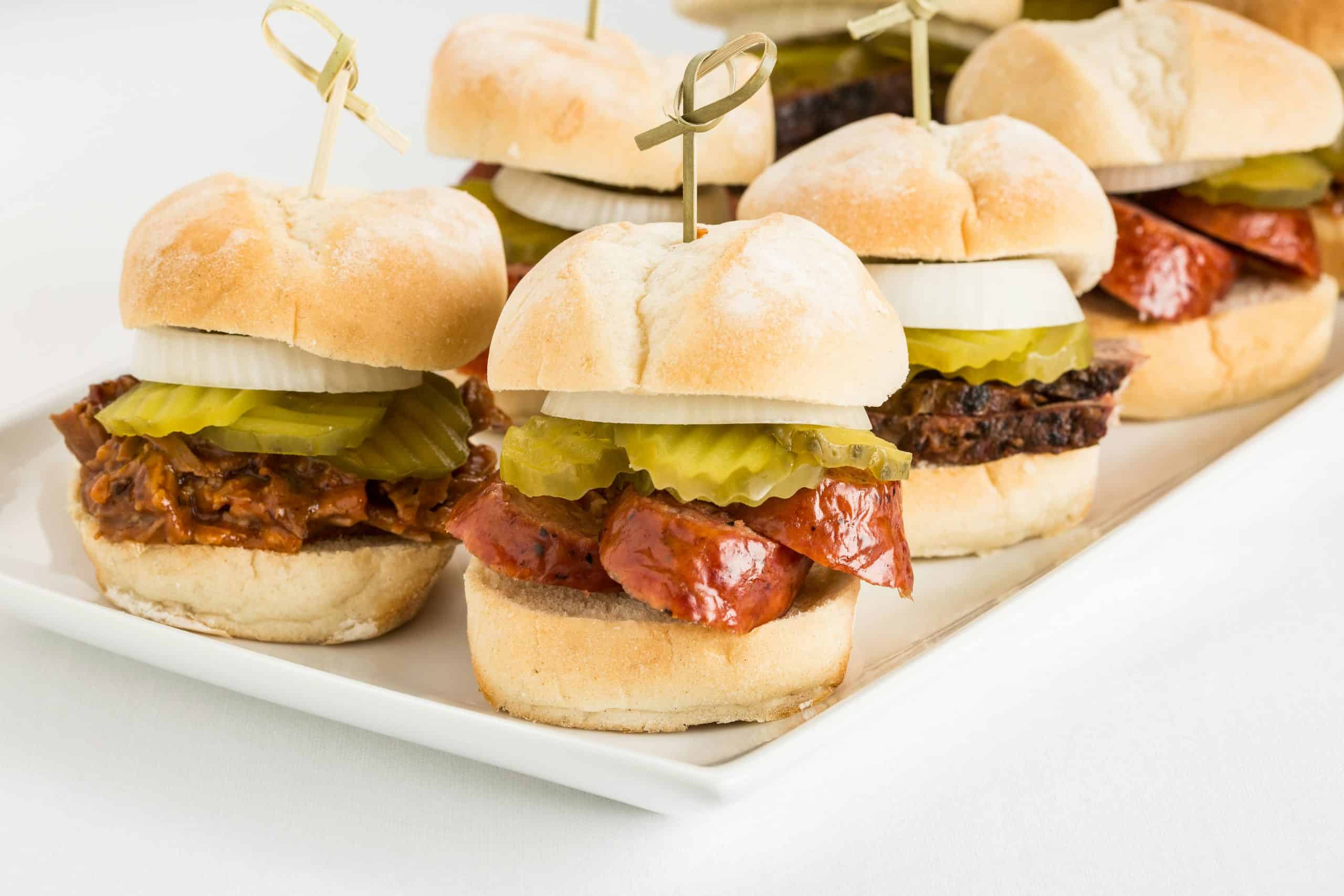 Tasty Texas-style BBQ beef sliders topped with pickles and onions, perfect for parties.