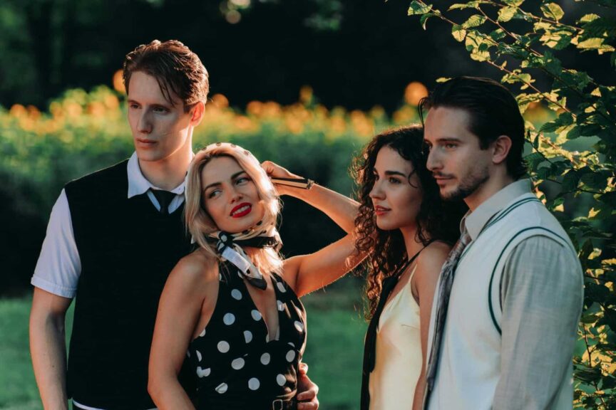 Four fashionable friends enjoying a sunny day in a garden setting. narcissism epidemic