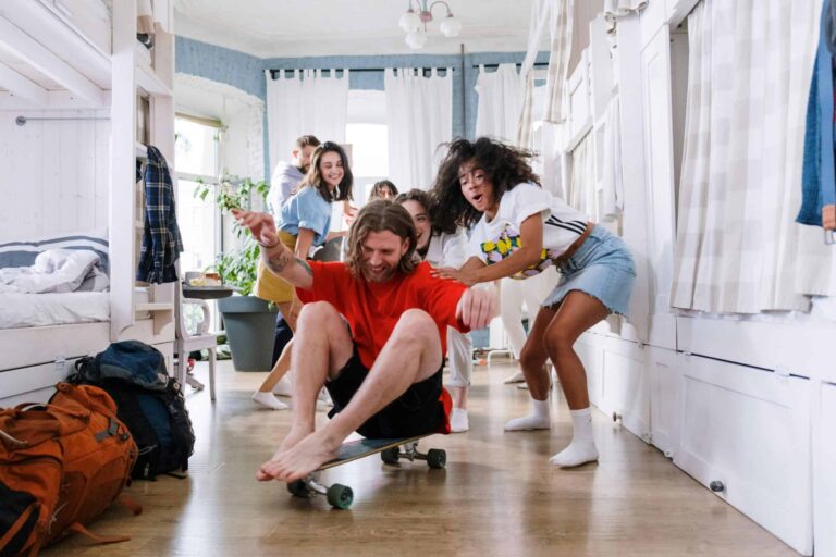 college roommates, A group of friends enjoying playful moments indoors, showcasing youthful spirit and camaraderie.