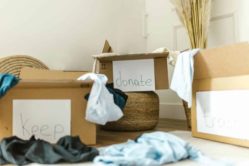 Cardboard boxes labeled keep, donate and trash, a simple sorting system for cutting clutter and stress at home