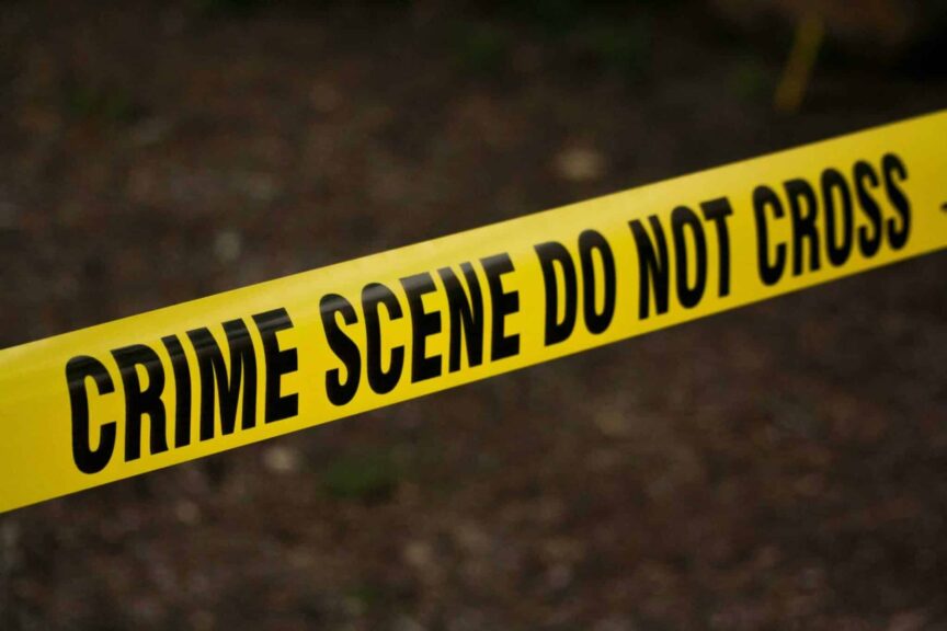 True-crime series concept image showing a close-up of yellow crime scene tape with “Do Not Cross” text in an outdoor setting. Photo by Kat Wilcox via Pexels.
