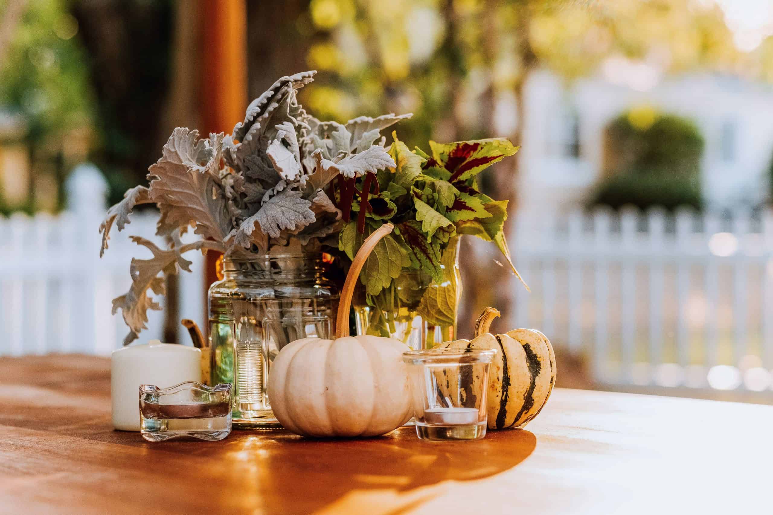 pumpkins, gourds, candles, on a table