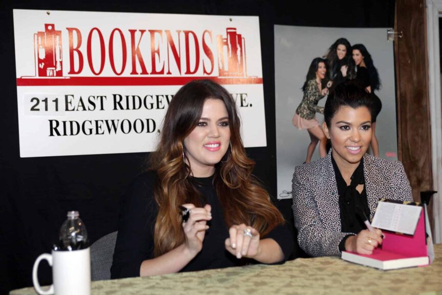Khloe and Kourtney Kardashian (L-R) pose for photos as they arrive for their book signing Wednesday evening at Bookends in Ridgewood, November 16, 2011.