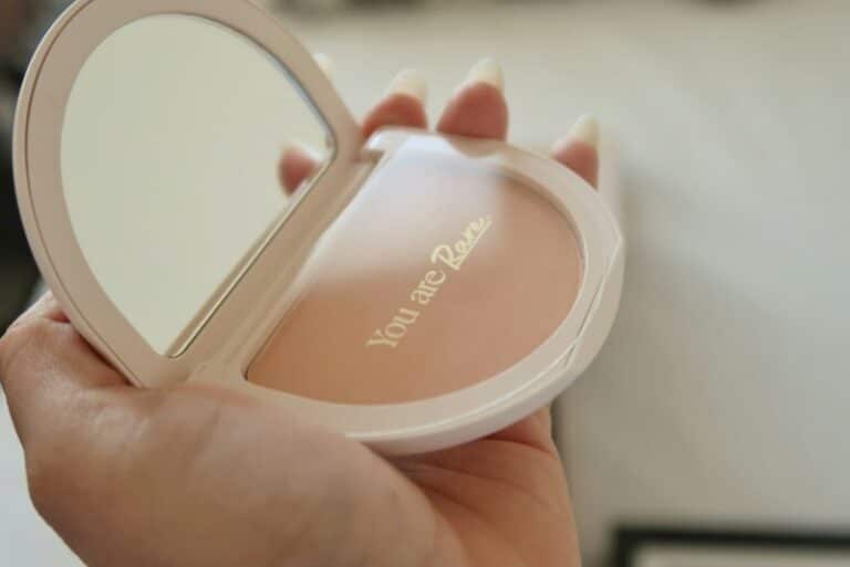 This photograph is of a compact. "You are Rare" is written inside." Rare Beauty is a makeup company begun by Selena Gomez.