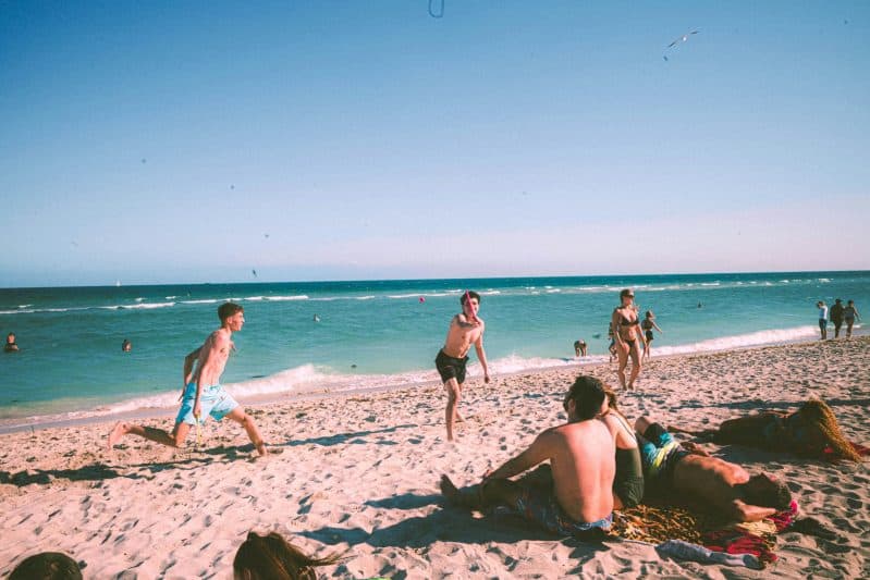 Teenagers on the beach, viral teen tattoo trend, sunburn tattoo