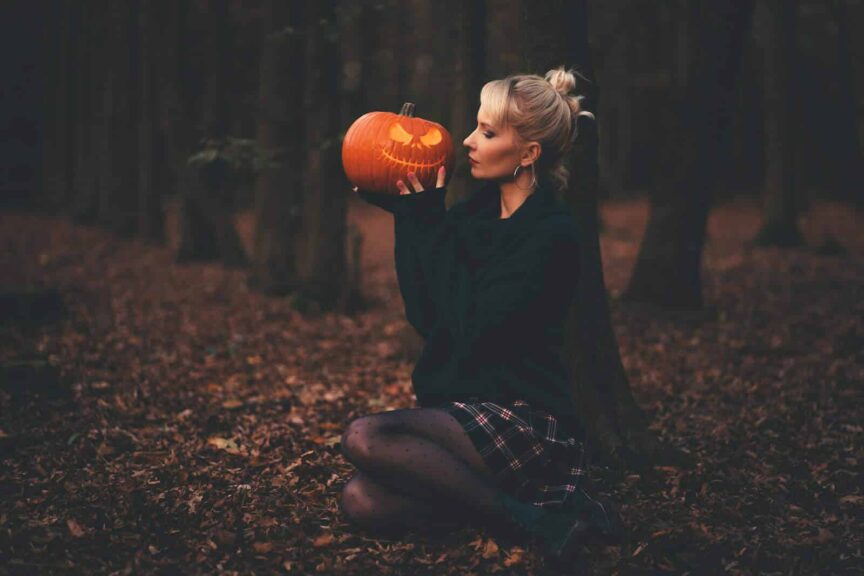 woman in black sweater holding pumpkin, Sexy Halloween Costume