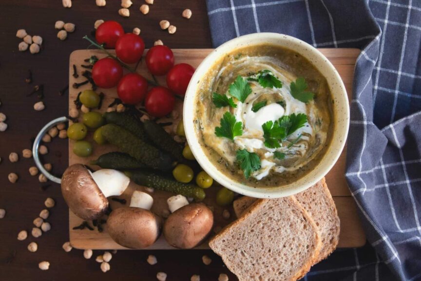 Delicious creamy soups with fresh vegetables and bread, perfect for food lovers seeking cozy comfort.