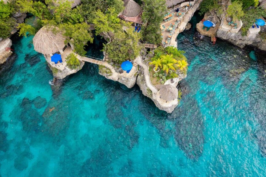Bluefields Bay Villas, Stunning aerial view of a cliffside resort in Negril, Jamaica, featuring turquoise waters and natural architecture.