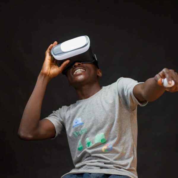 A young black man enjoying virtual reality with a headset, indoors.AR and VR Sports Games