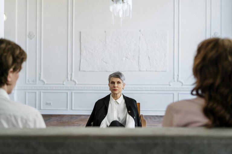 A married couple in a consulting session with a therapist in a modern, minimalistic office. conscious uncoupling