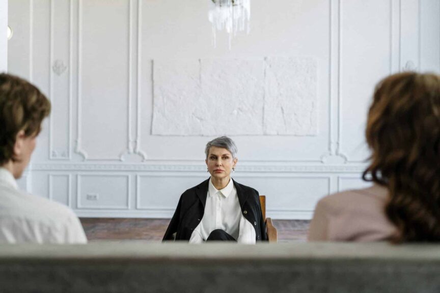 A married couple in a consulting session with a therapist in a modern, minimalistic office. conscious uncoupling