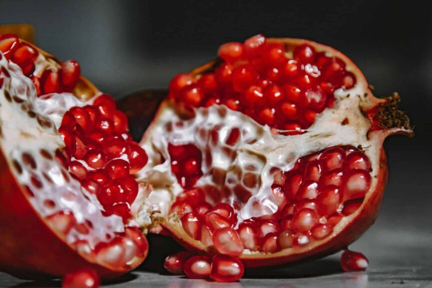 immune system, A close-up shot of a juicy pomegranate revealing vibrant red seeds and textured skin.