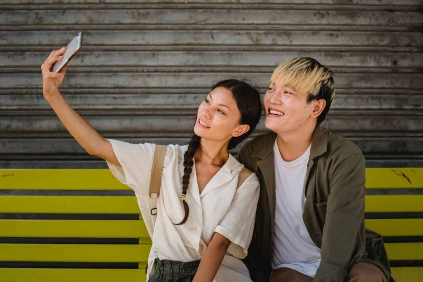 This photograph is of a couple taking a selfie together. Soft-launching a relationship through social media can let people how excited you are.
