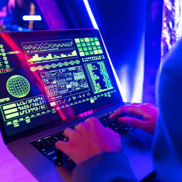 Person typing on a laptop with vibrant digital data display, highlighting cyber security. nano11
