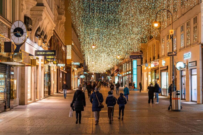 Armani, hotels, Night view of Vienna's bustling street adorned with holiday lights, capturing the festive vibe.