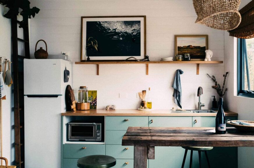 This photograph features a kitchen with wood incorporated into the decor. Wood countertops can work well as part of a variety of kitchen looks.