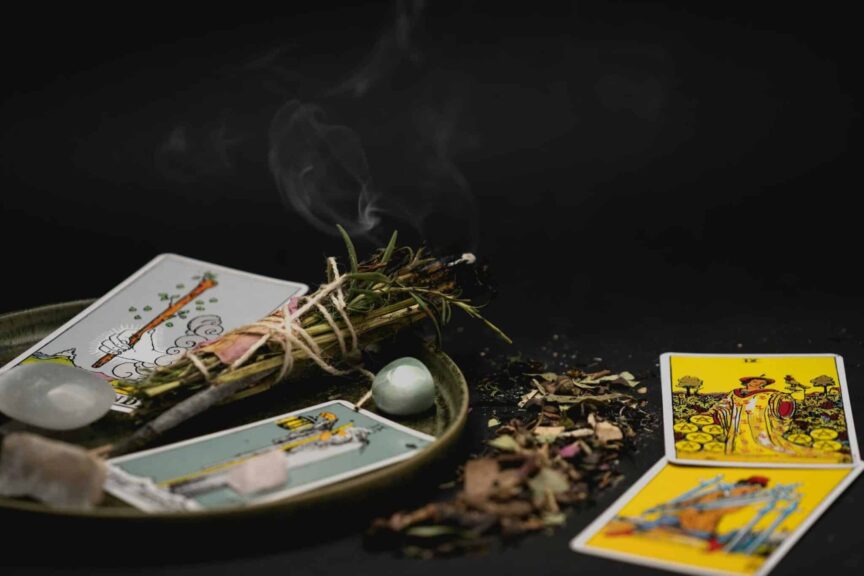 Tarot horoscope A spiritual still life with tarot cards, herbs, and crystals on a dark surface for meditation.