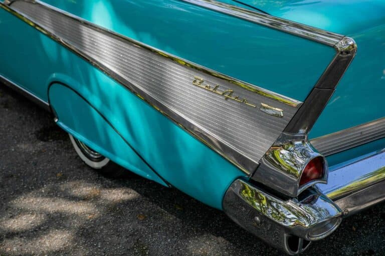 Close-up of a vintage turquoise Chevrolet Bel Air convertible showcasing its retro tail fin design.