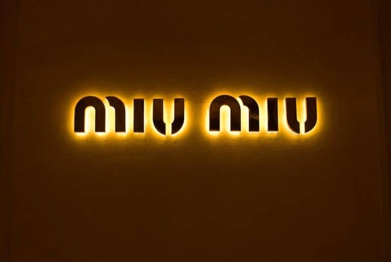 This is a photograph of the Miu Miu logo. The Arcadie handbag is a popular Miu Miu item.