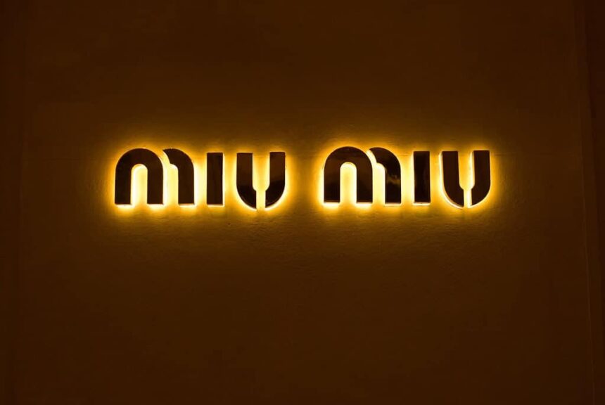 This is a photograph of the Miu Miu logo. The Arcadie handbag is a popular Miu Miu item.