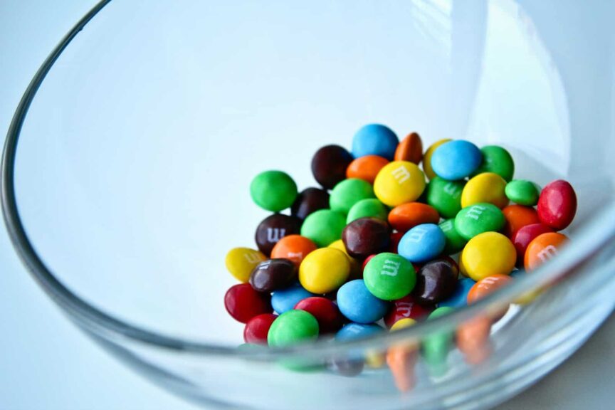 a glass bowl filled with lots of colorful candy. M&M's candy M&M's candy rescue