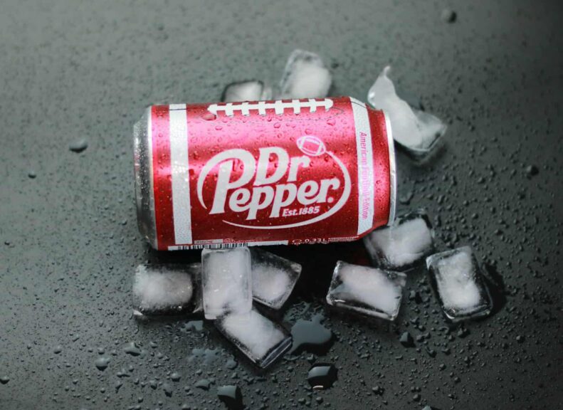 a can of soda sitting on top of ice cubes, whipped dr pepper, viral drink,