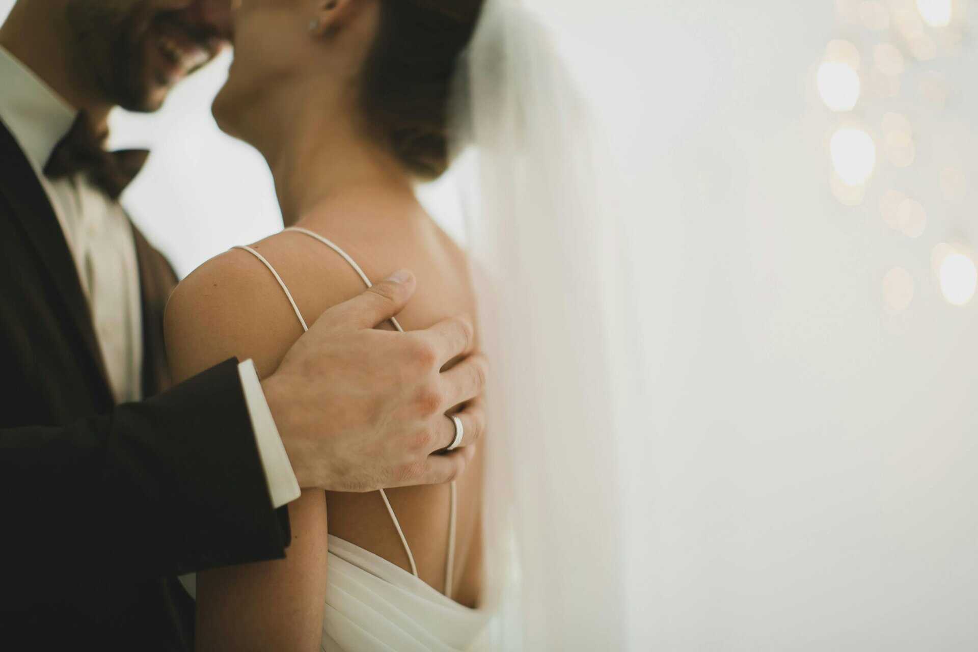 Intimate close-up of a newlywed couple embracing, showcasing love and togetherness, happy marriages