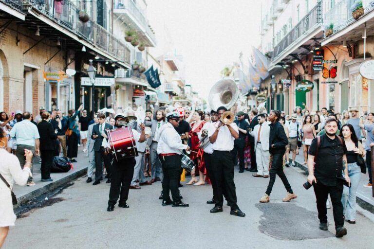 New Orleans, autumn, fall, halloween, travel A lively street parade with musicians and crowds in the heart of New Orleans, capturing the festive spirit of the city.