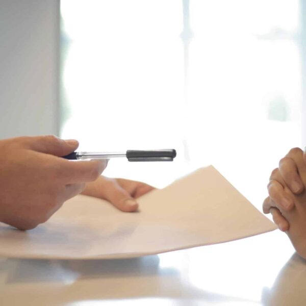 Close-up of a contract signing with hands over documents. Professional business interaction. lawyer