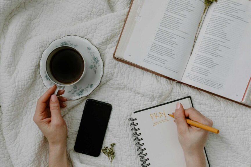 A serene morning meditation scene with coffee, Bible, and journal, daily devotion