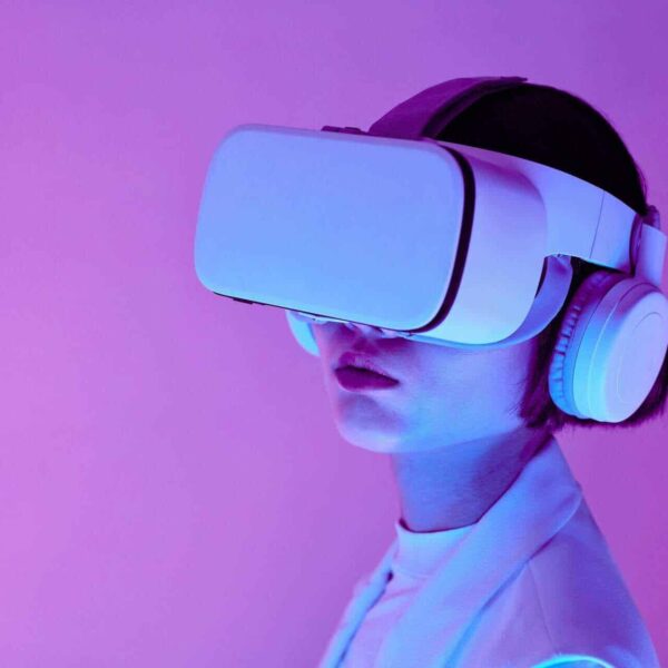 Woman explores virtual reality with VR goggles in modern studio light./ AI