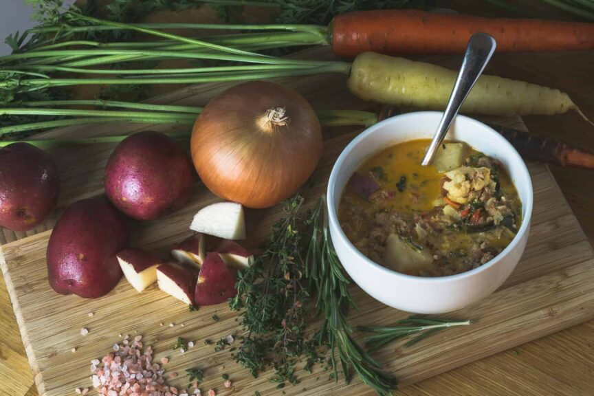 A homemade root vegetable soup with fresh ingredients, perfect for a cozy dinner. Fall foods for gut health.