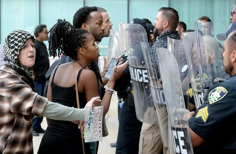 Protesters confront Springfield Police officers holding riot shields during a police protest at the Municipal Building East which headquarters the Springfield Police Monday, Sept. 9, 2024.