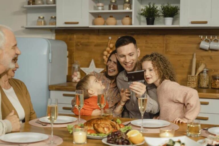 This photograph features a family having festive dinner together. The holidays can be a time of productive discussion about ways to co-parent.