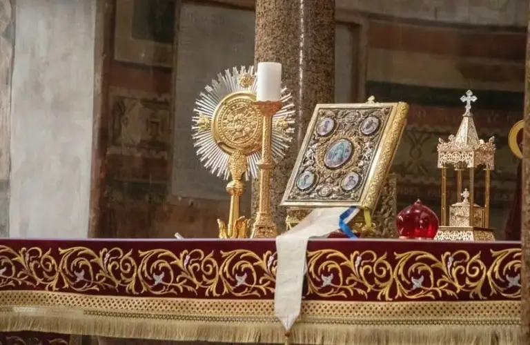 Roman Catholic church altar in Rome, Italy topped with bible and religious items, Saint Aloysius de Gonzaga, Saint Syncletica