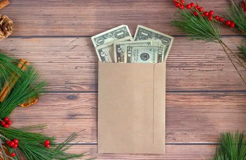 Envelope of money on a table with winter decoration, mental health, money stress