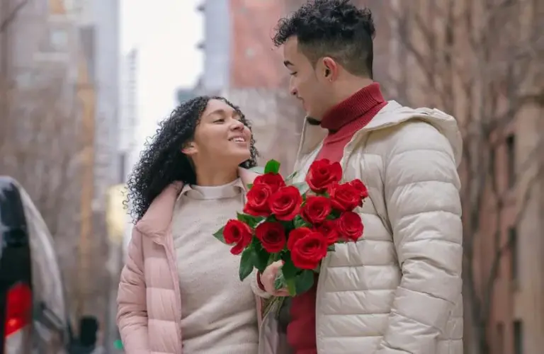 couple together holding roses. winter date ideas
