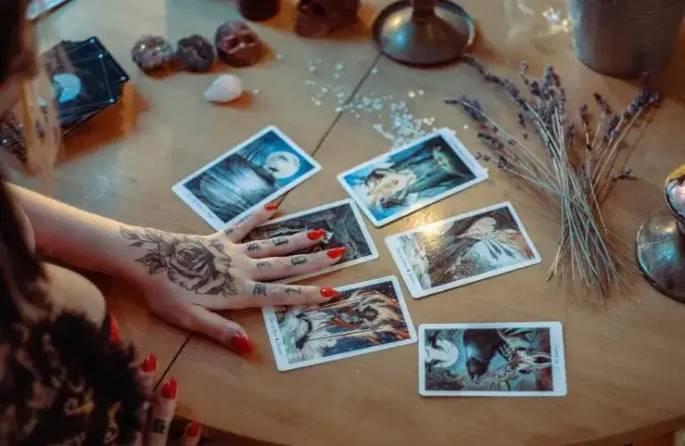 Assorted Tarot cards on a table that could be used to help determine your birth card.