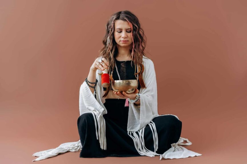 A serene woman meditates with a singing bowl, evoking a sense of peace and balance, Native American, wellness