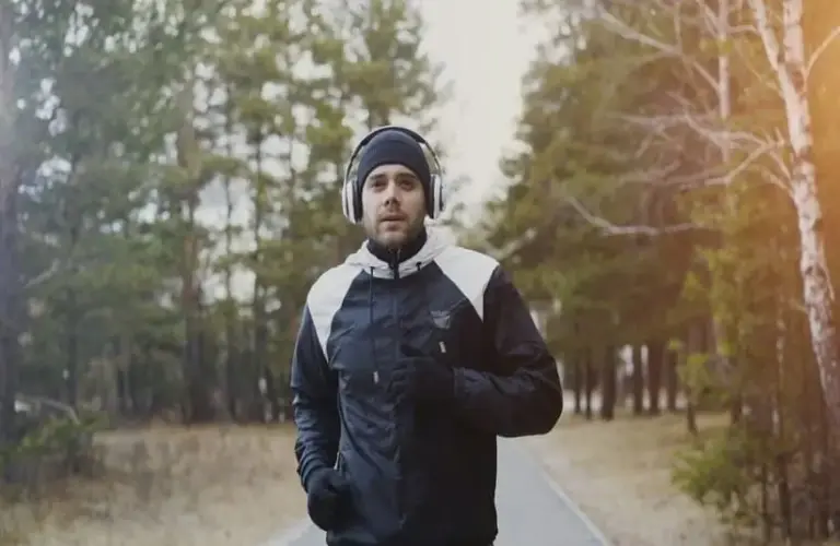 Man running outdoors in winter, winter fitness